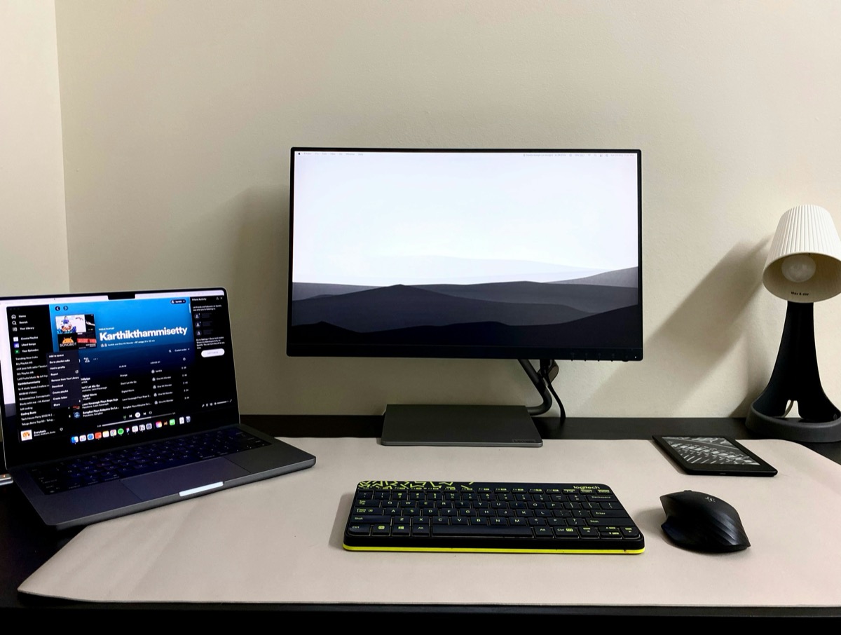 Desk setup with laptop, keyboard, mouse and external monitor