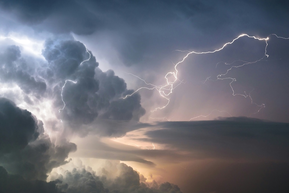 A dramatic lightning strike illuminates stormy clouds