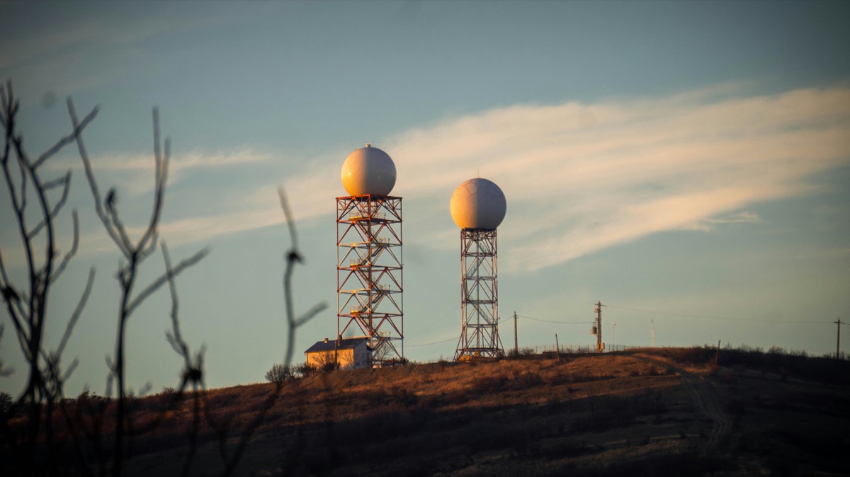 Radar domes on towers on a hilltop